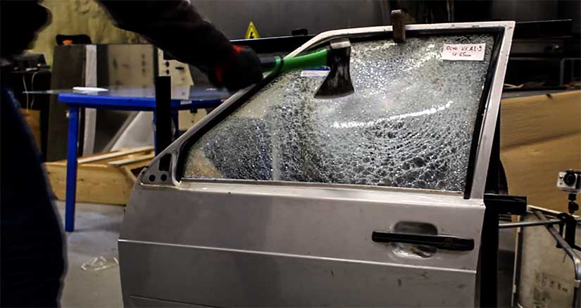 Test of vandal-proof glass by hand, axe